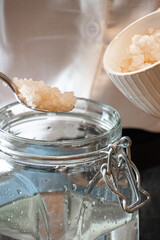 Adding water kefir grains to jar for fermentation