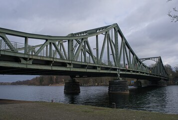 Potsdam, Germany - Jan 23, 2024: Glienicke Bridge. The bridge of  spies. Former border crossing between East and West Germany. Cloudy winter day. Selective focus
