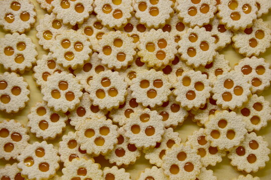 Christmas biscuits baking, rogues, shortcrust pastry biscuits sprinkled with jam and icing sugar, Christmas background