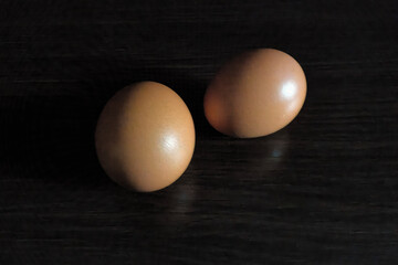 chicken eggs on black background