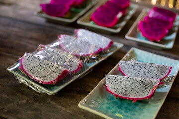selective focus, specially selected dragon fruit Wrapped with clear plastic. fruit on ceramic plates Prepared for after lunch for customers.