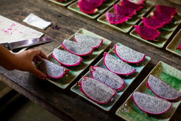 selective focus dragon fruit Fruits are arranged on ceramic plates and lunch is served to customers.