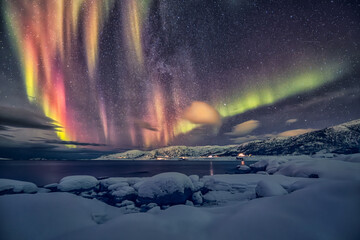 An aurora, also commonly known as the northern lights or southern lights, is a natural light display in Earth's sky, predominantly seen in high-latitude regions. Auroras display dynamic patterns of br - obrazy, fototapety, plakaty