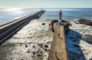 Sentinel of the Sea: Majestic Lighthouse Adorns the Porto Pier, Overlooking the Vast Ocean.