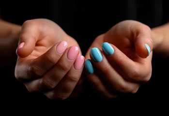 hands with pink and blue manicured nails © olegganko