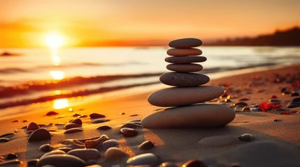 Fotobehang balance stack of zen stones on beach during an emotional and peaceful sunset, golden hour on the beach © Usman