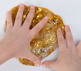 Kid play with gold color slime