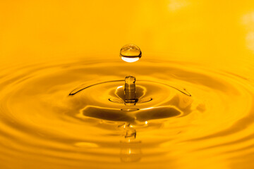 yellow drop oil , Liquid gold oil drop ripple background.