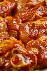 Fresh chicken wings and thighs marinated in red sauce at the butcher shop