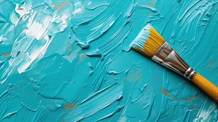 a paintbrush with a yellow bristles on a blue paint - chiped surface with white streaks of paint.