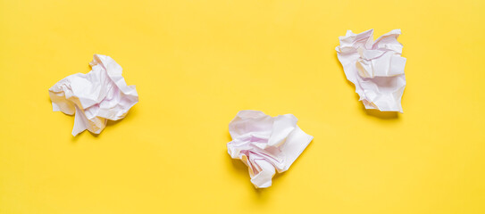Crumpled White Paper Sheets on Yellow Background in Office Environment. Banner
