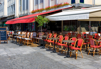 Typical view of the Parisian street with tables with tables of cafe in Paris, France. Architecture and landmark of Paris. Cozy Paris cityscape - 737189612