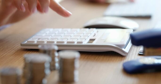 Female hands using calculator carry out calculation for laptop calculates expenses. Business home expenses and budget management accounting concept