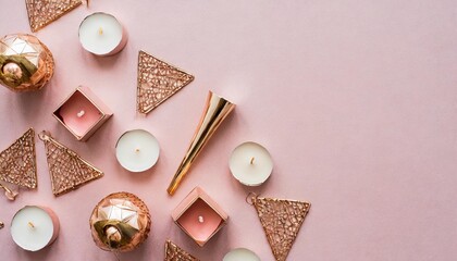 beautiful geometric pattern of candlesticks and candles in rose gold on a pink background flat lay top view copy space