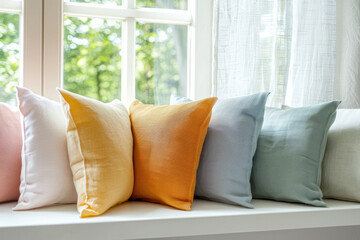 Closeup and front shot about chic home accessories like elegant fiber pillows in front of a window,...