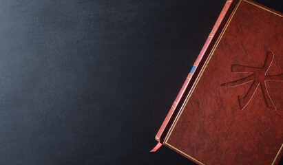 Background with sacred book with engraved confucian symbol top view