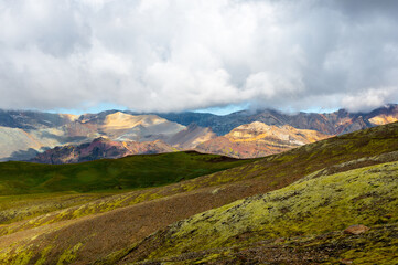 Hiking in the Skaftafell Nationalpark with a view on colorful rainbow mountains. Skaftafellsheidi hiking trail, Vatnajökull National Park, Iceland