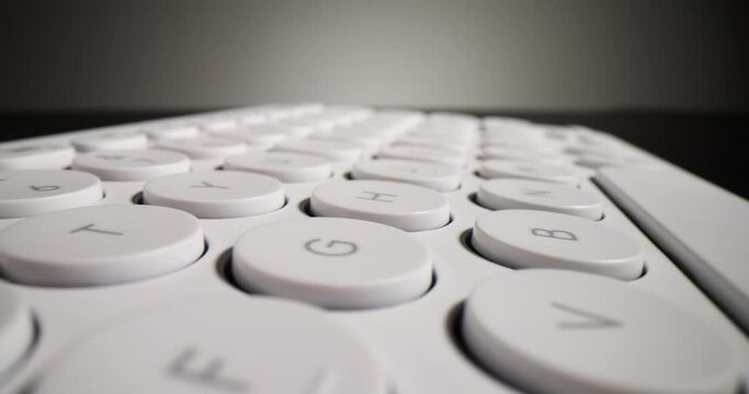 White computer keyboard on black background. Computer technology concept