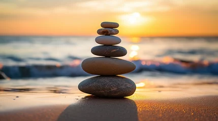Gartenposter balance stack of zen stones on beach during an emotional and peaceful sunset, golden hour on the beach © Zainab