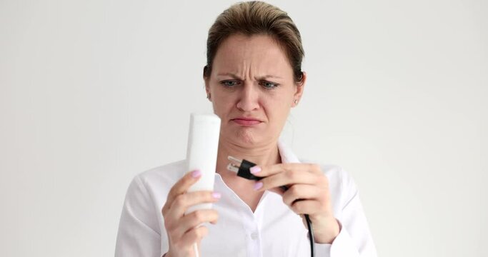 Woman can not inserting plug with wrong connector into socket and surprising 4k movie slow motion. Sale of adapters concept