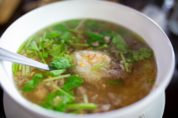 Rice vermicelli soup with minced pork in white bowl