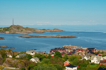 Fototapeta premium View of traditional Lofoten village Å i Lofoten with red fisherman's cabins rorbu, sea and mountains on Moskenesøya island, Lofoten islands, Nordland, Norway. Travel Scandinavian background