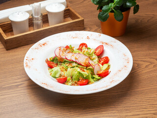Vegetable salad: radishes, tomatoes, lettuce. Lunch.