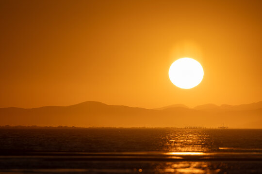Disfruta la belleza impresionante del sol despidi&eacute;ndose del d&iacute;a, pintando el cielo con tonos dorados y carmes&iacute; sobre la tranquila extensi&oacute;n de la playa