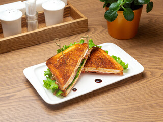 Sandwich with chicken, cheese and tomato. Breakfast.