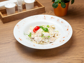 Farfalle with chicken in a plate. Lunch.
