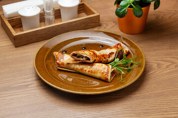 Pancakes stuffed with mushrooms and onions. Breakfast.