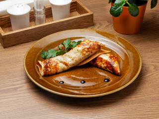 Pancakes stuffed with chicken and mushrooms. Breakfast.