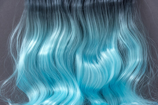 Blue hair in the style of Ombre. Coloring and hair extensions. The texture of natural hair.