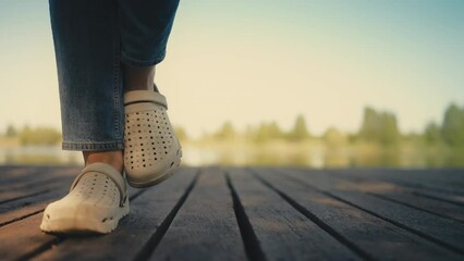 Woman waiting to go to the bathroom while standing on wooden beach dock