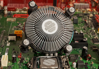 Close-up view of a CPU heatsink resting on the motherboard. Dried thermal paste residue on the...