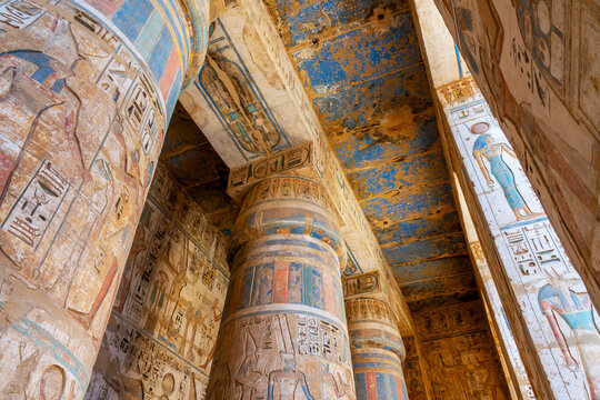 Colorful hieroglyphs carved on columns, interior of Medinet Habu temple on Luxor west bank, Egypt