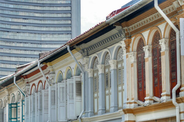 Traditional Straits Chinese Shophouses against skyscrapers in Singapore