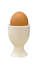 A hard-boiled egg sits on a white ceramic egg cup. Cooked chicken eggs in egg container on white...