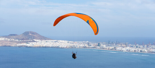Paraglider flying in the city of Las Palmas de Gran Canaria in Spain