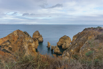 Famous rock formation of cliff in golden sunlight at the atlantic coast line near Ponta da Piedade,...