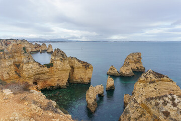 Famous rock formation of cliff in golden sunlight at the atlantic coast line near Ponta da Piedade, Lagos, Algarve, Portugal.