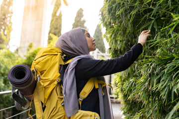 woman with veil on hiking route has contact with nature and plants - woman empowerment