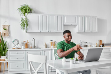 cheerful deaf african american freelancer using sign language for communication during video call