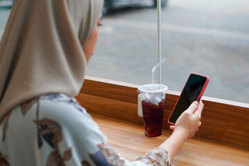 Modern Muslimah woman. Indonesian Woman in Hijab Embracing Digital Connectivity with Smartphone