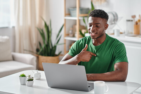 african american man communicating with sigh language during online meeting on laptop, virtual