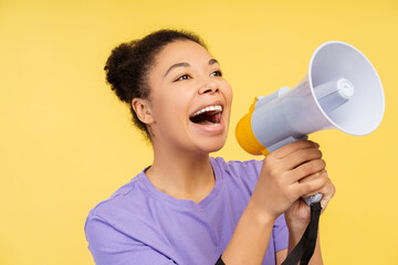 Portrait of smiling beautiful African American woman holding megaphone announcing, talking something