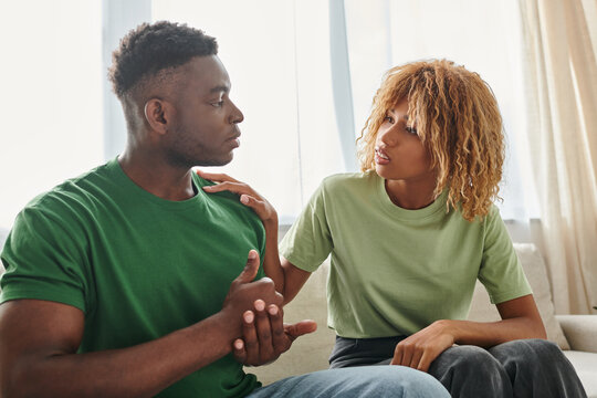 black man showing help gesture while communicating with worried girlfriend and using sign language