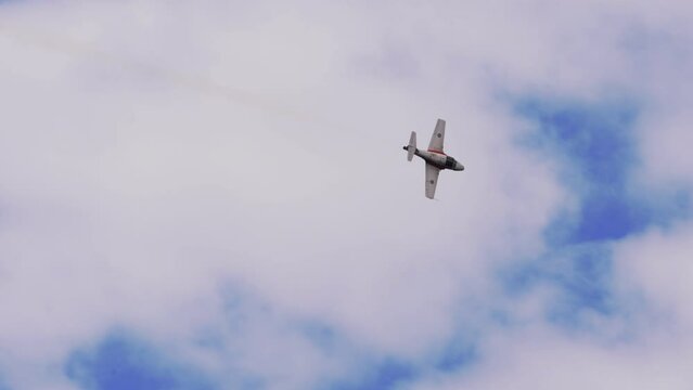 Panning Shot Of Aircraft Flying In White Cloudy Sky - Huntington Beach, California