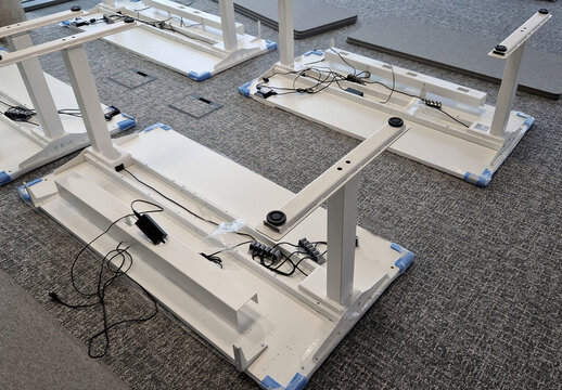 installing office desks starts with assembling the legs in place. preparing furniture for carpet flooring. connecting the drive of the extendable table to the computer. positionable