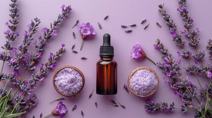 Lavender spa products and lavender flowers on purple background, top view